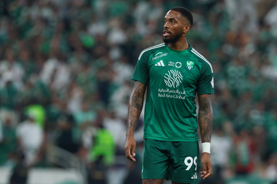 a soccer player wearing a green jersey that says red sea global