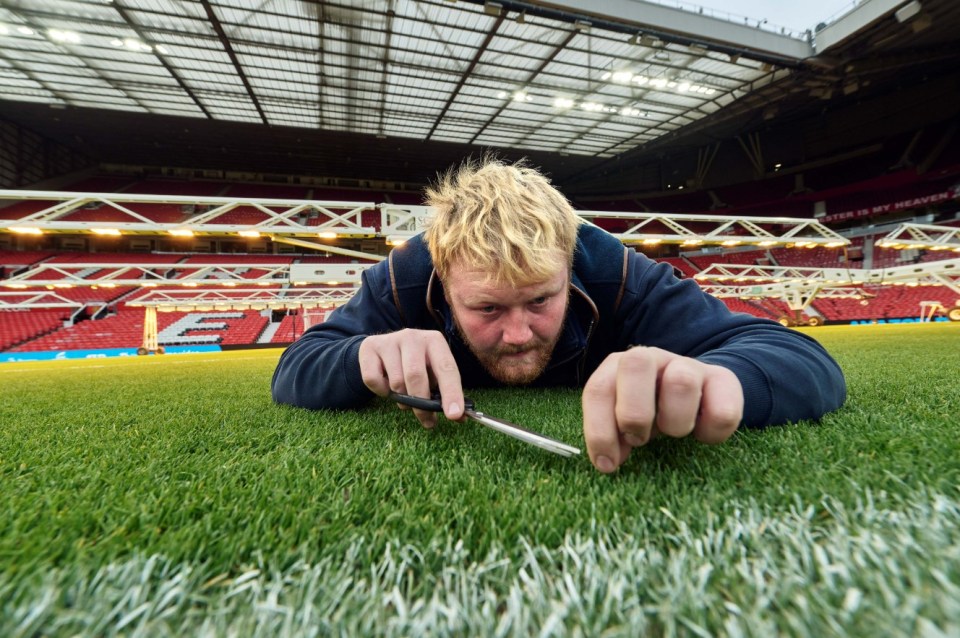 a man laying on a soccer field with the letter e on it
