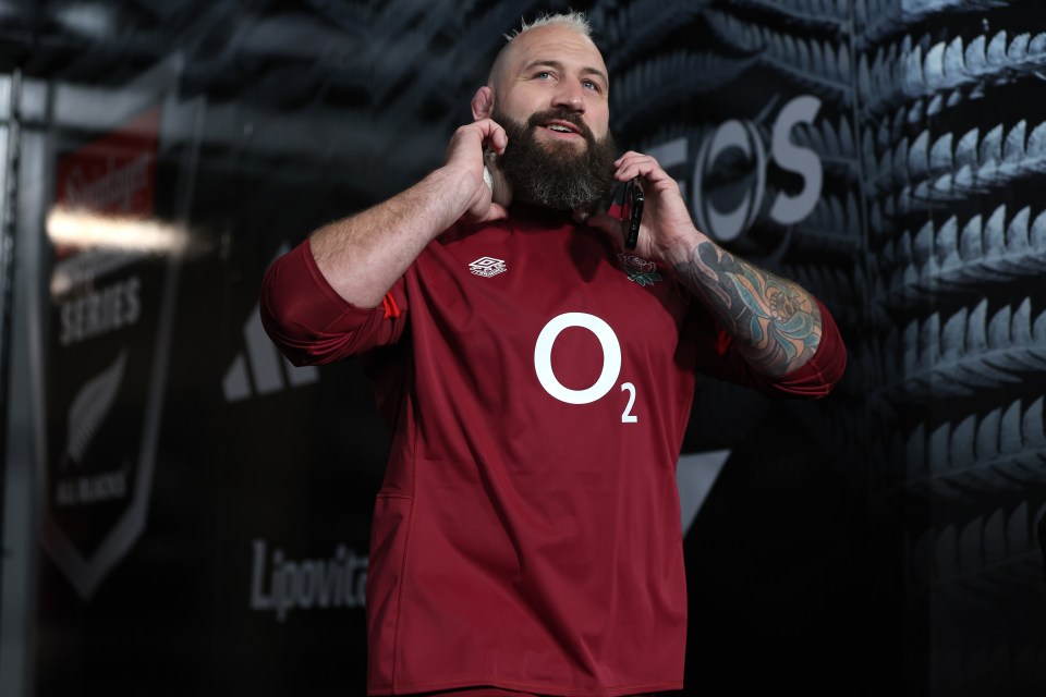 a man with a beard wearing a red o2 jersey