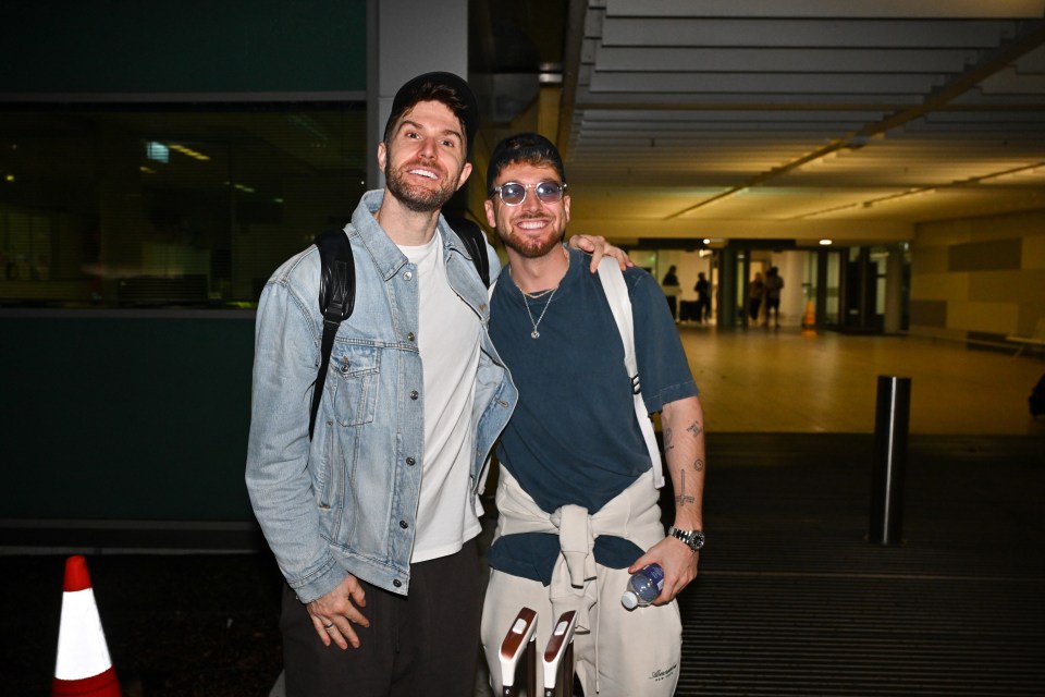 two men posing for a picture with one wearing sunglasses
