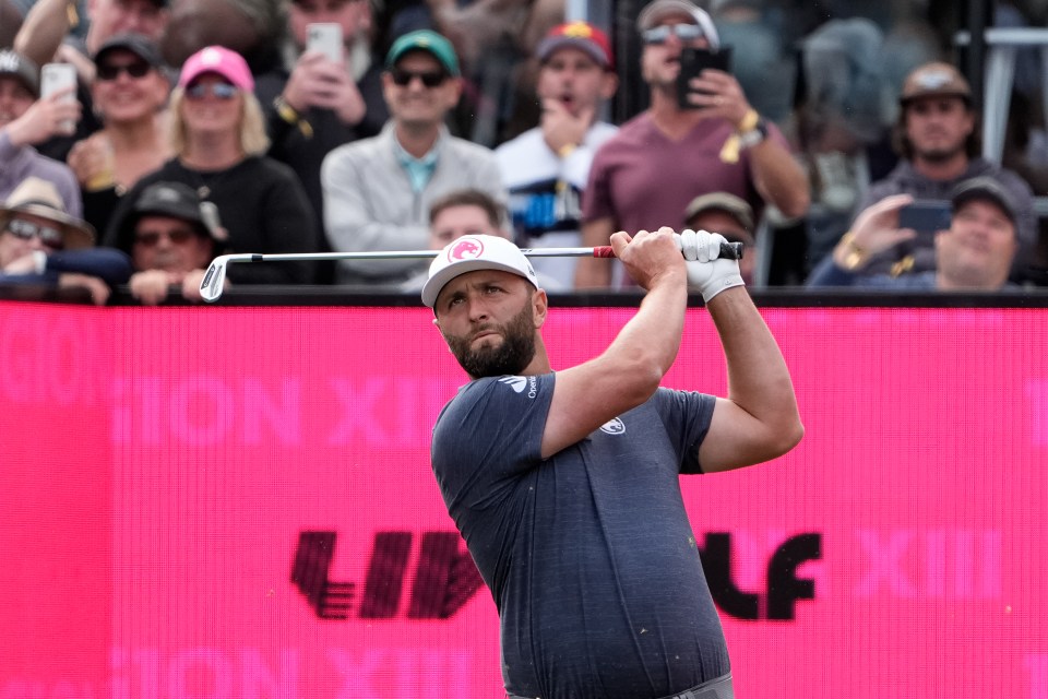 a man swings a golf club in front of a sign that says lip