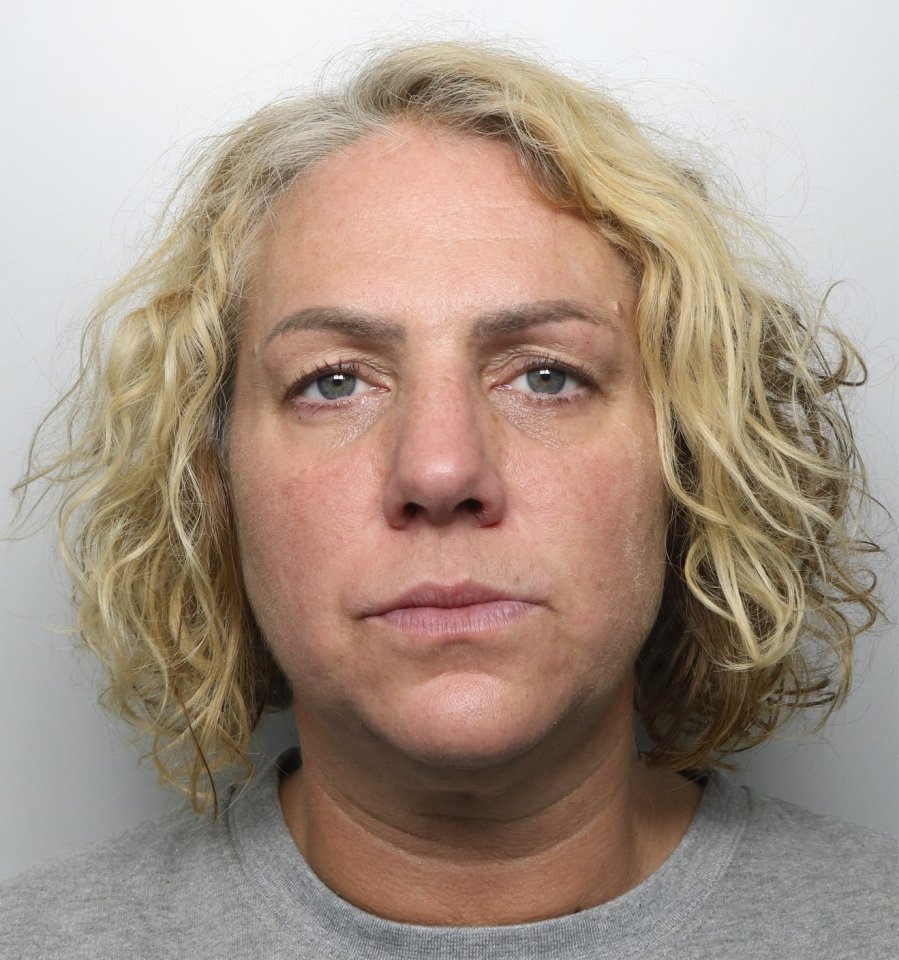 a woman with blonde curly hair is wearing a grey shirt