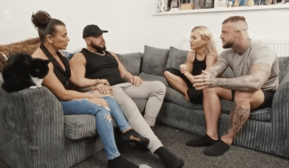 a group of people sitting on a couch with one wearing a pair of black socks that say bench