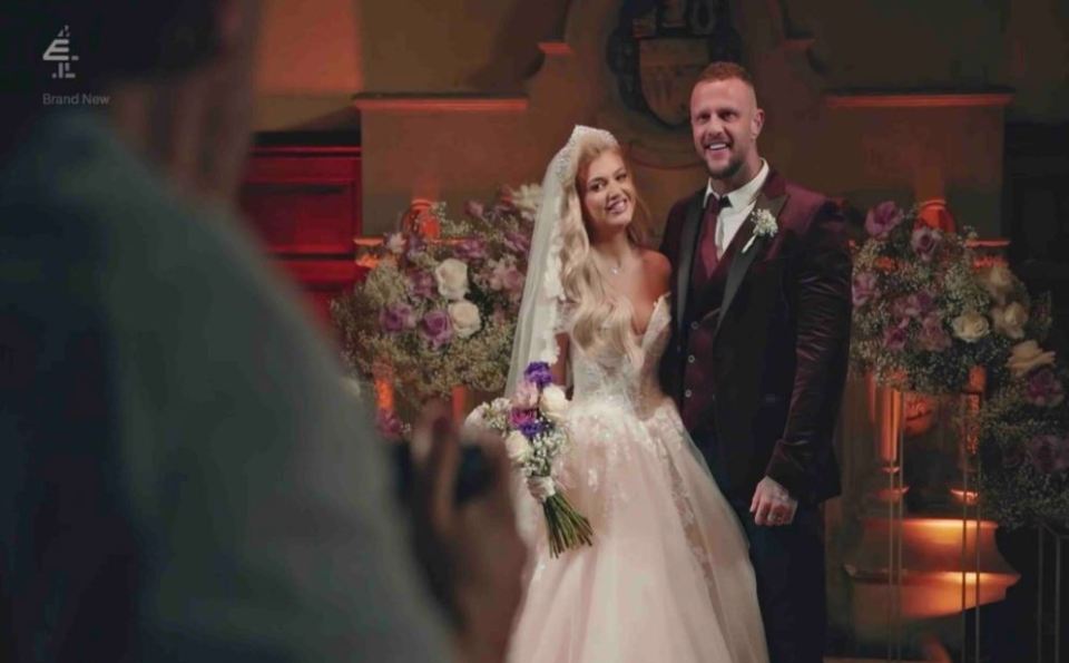a man is taking a picture of a bride and groom at their wedding
