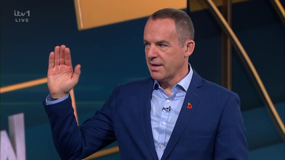 a man in a blue suit waves his hand in front of itv1 live