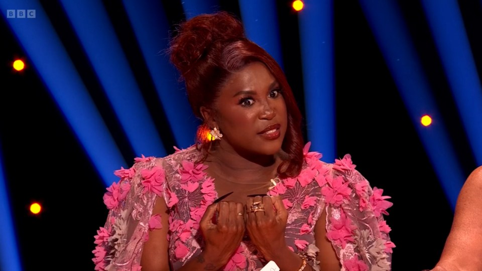 a woman in a pink dress with a bbc logo on the bottom right
