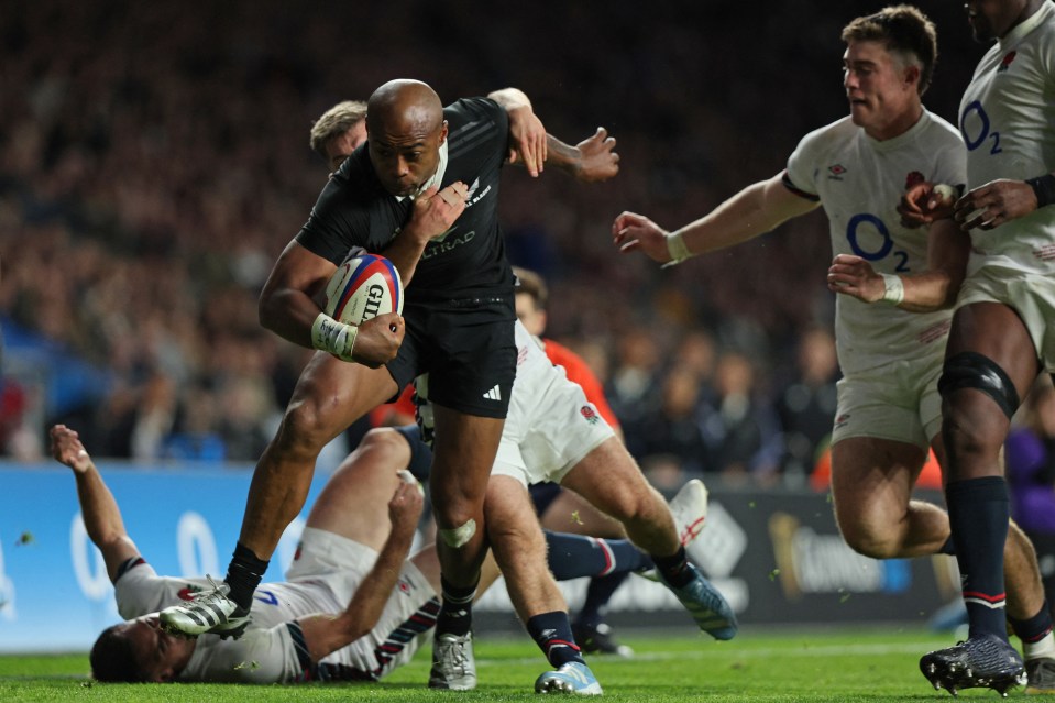 a rugby player wearing a black jersey with the word all blacks on it