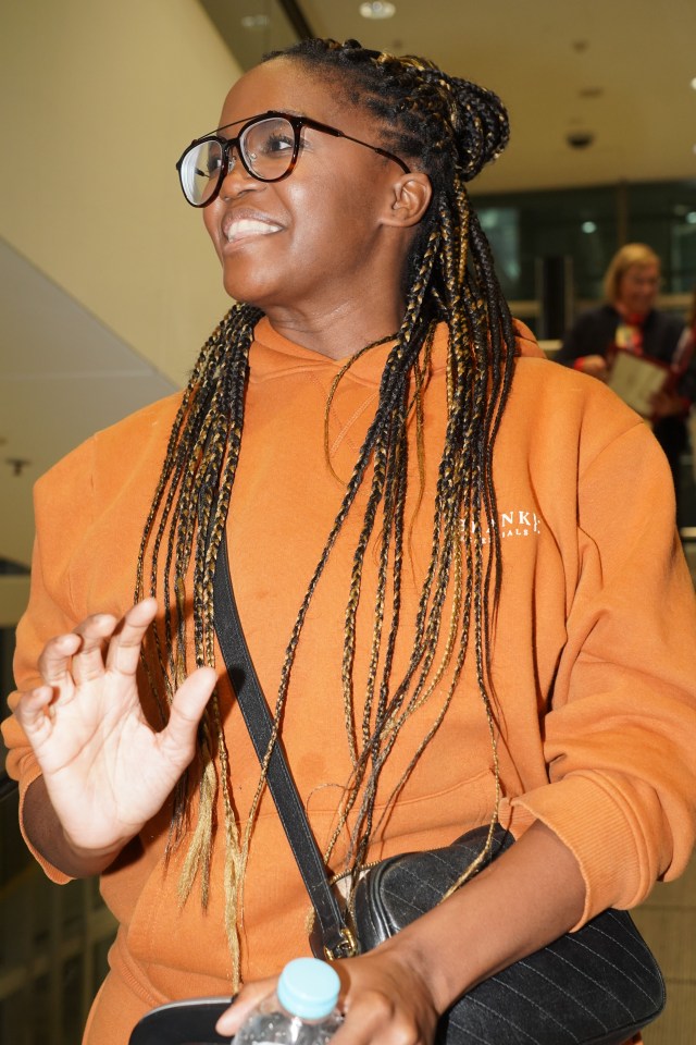 a woman wearing glasses and a hoodie that says ' nk ' on it