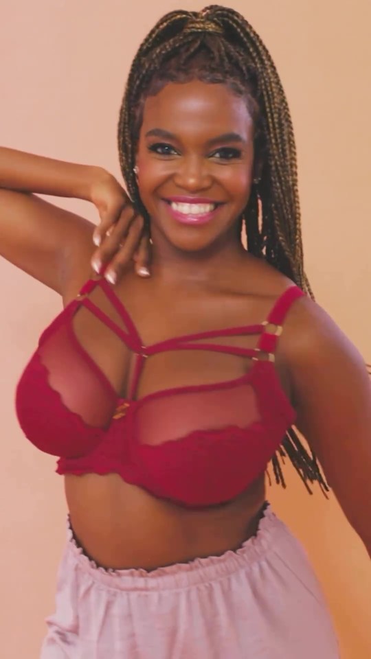 a woman with braids is wearing a red bra