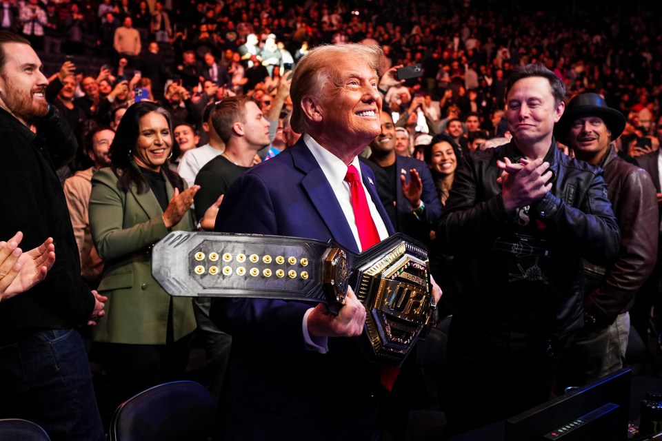 a man wearing a ufc glove talks to a man in a suit