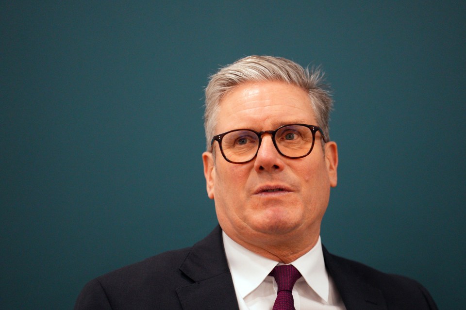 a man in a suit and tie is wearing glasses