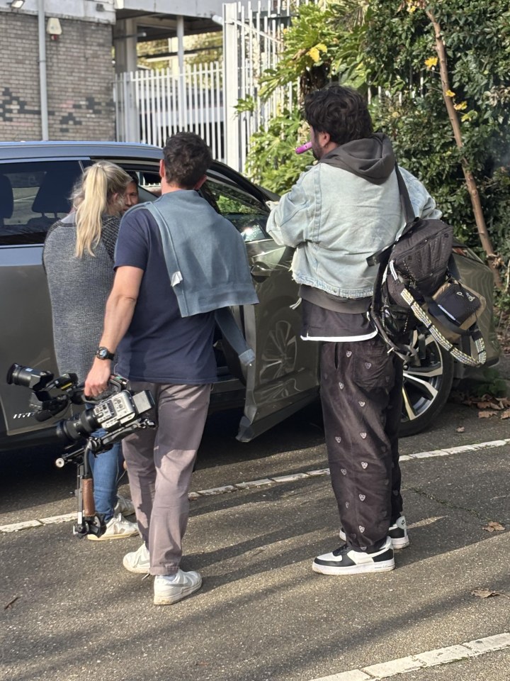 a man carrying a camera that says ' nikon ' on it