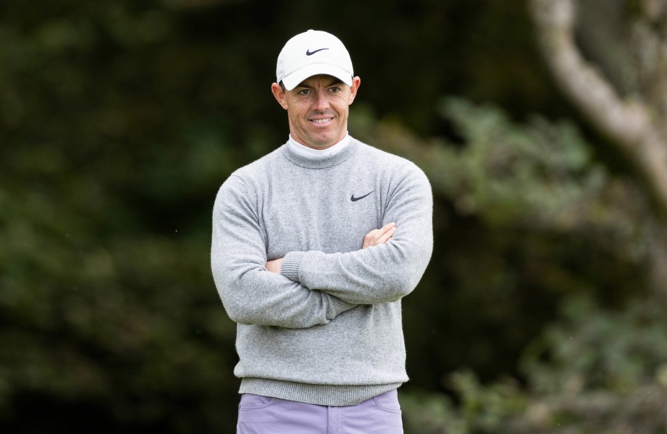 a man with his arms crossed wearing a nike hat