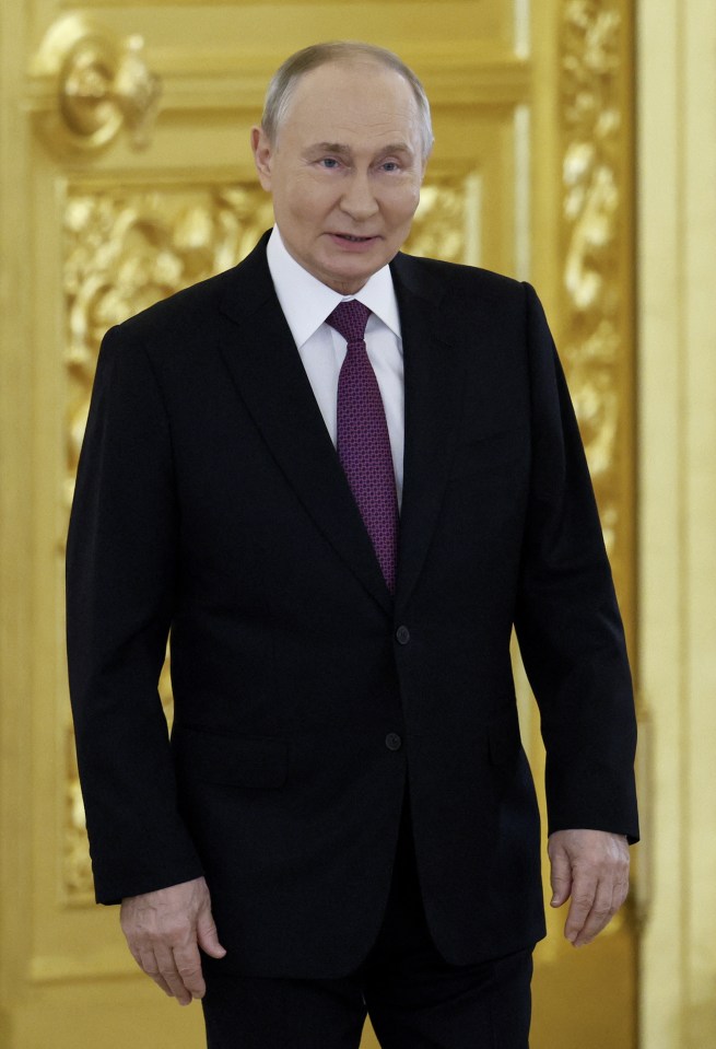 a man in a suit and tie stands in front of a gold door