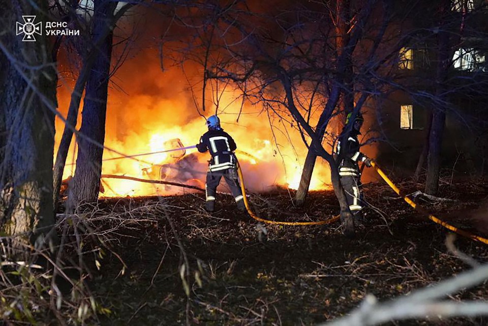 a group of firefighters are fighting a fire in the woods