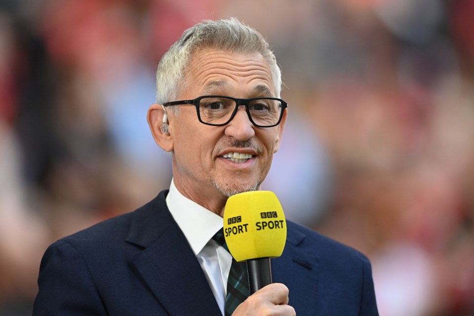 a man with glasses and a yellow microphone that says bbc sport
