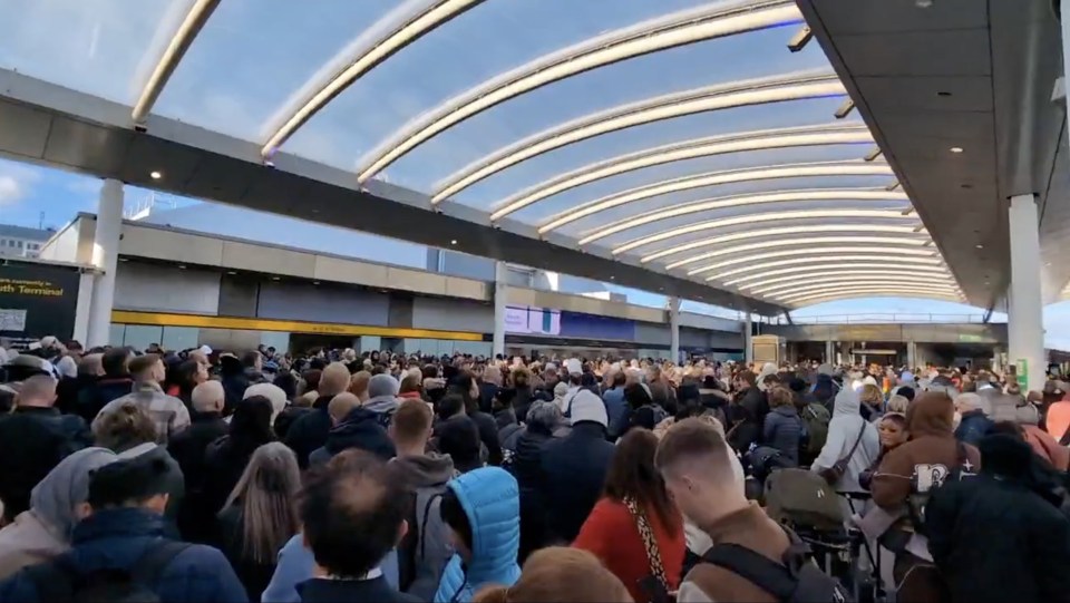 a large crowd of people are gathered in front of a building that has the word terminal on it