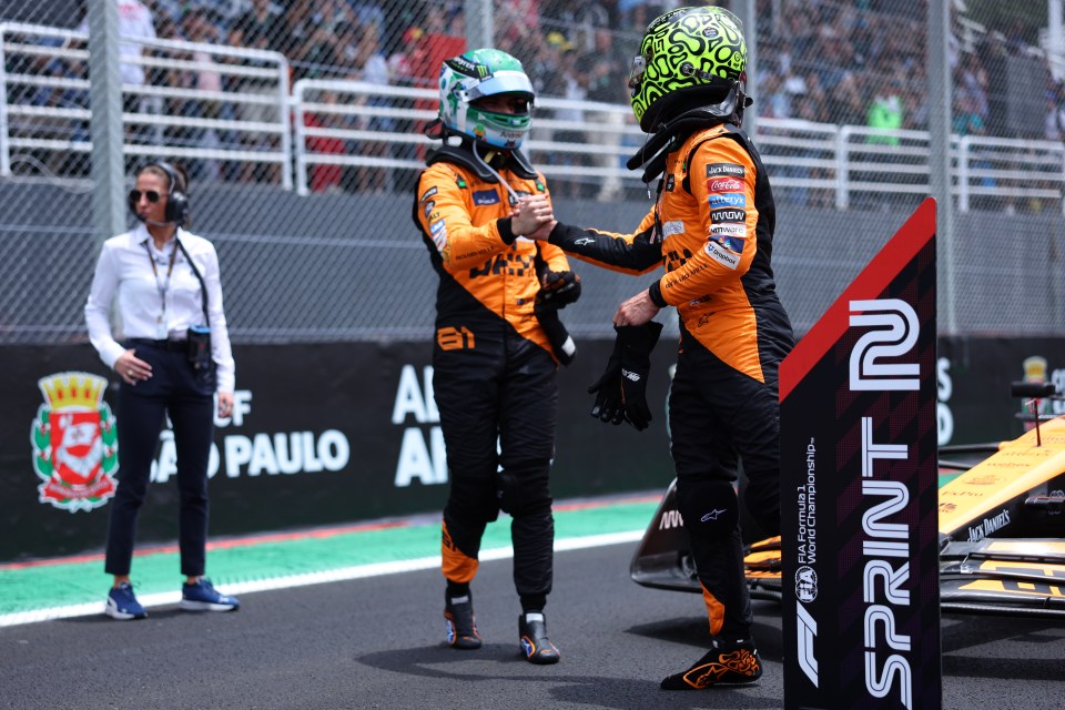 two race car drivers shake hands in front of a sign that says sprint 2
