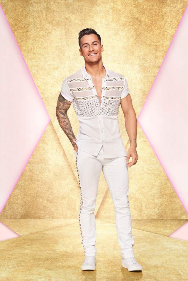 a man in a white shirt and white pants is smiling
