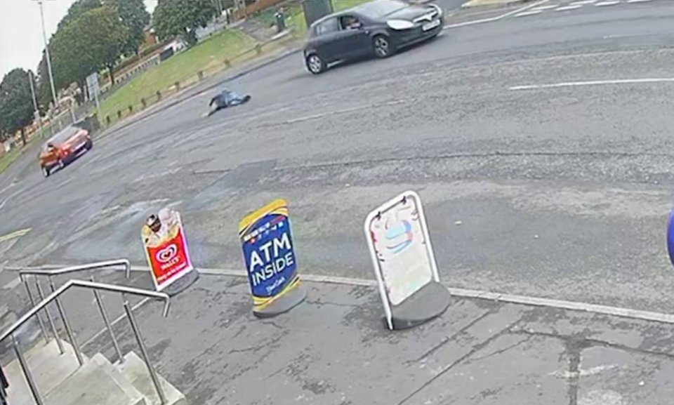 a car is driving past a sign that says atm inside