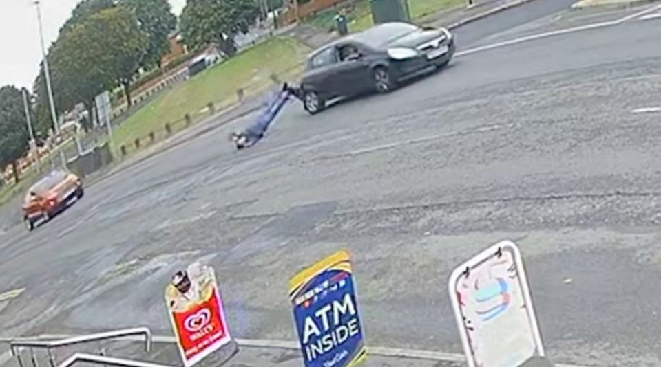 a car is driving down a street next to a sign that says atm inside .