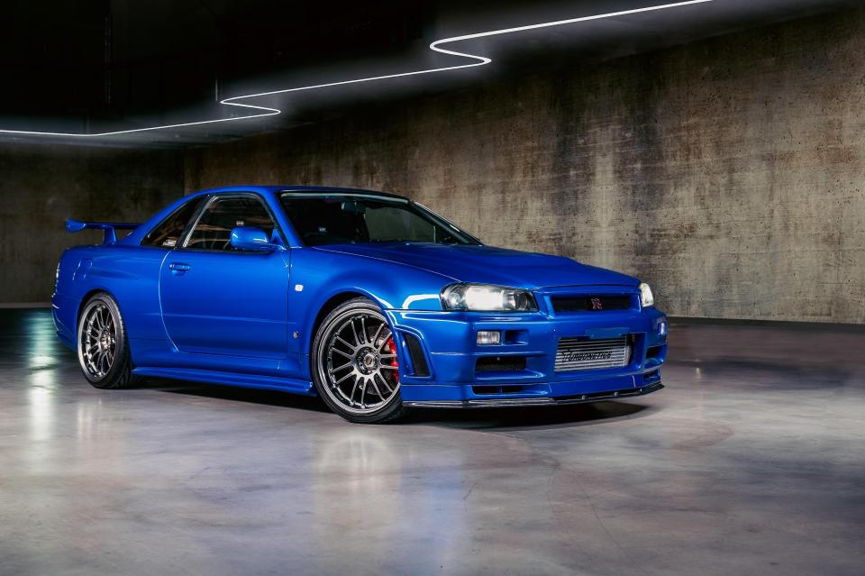 a blue sports car is parked in a garage