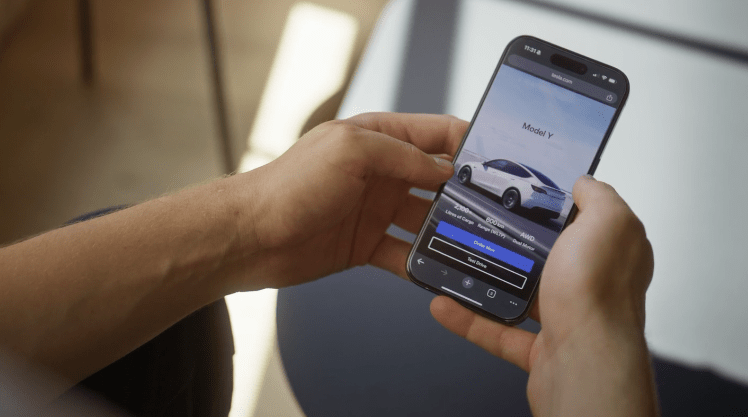 a person is looking at a model y on their phone