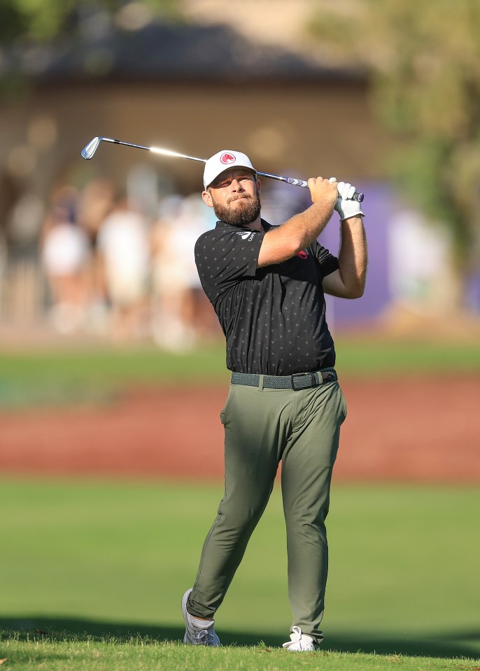 a man with a beard is swinging a golf club