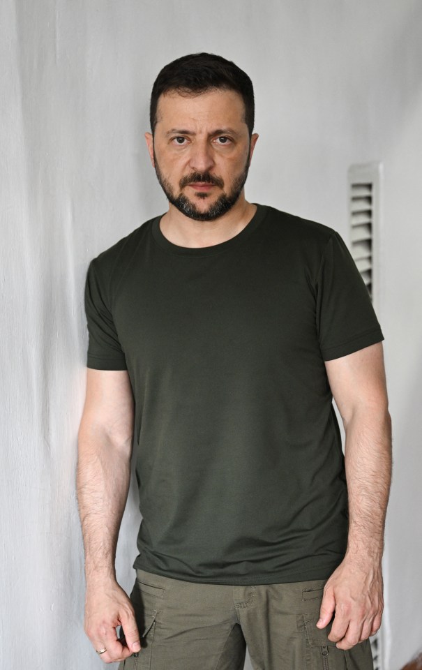 a man with a beard is wearing a green t-shirt