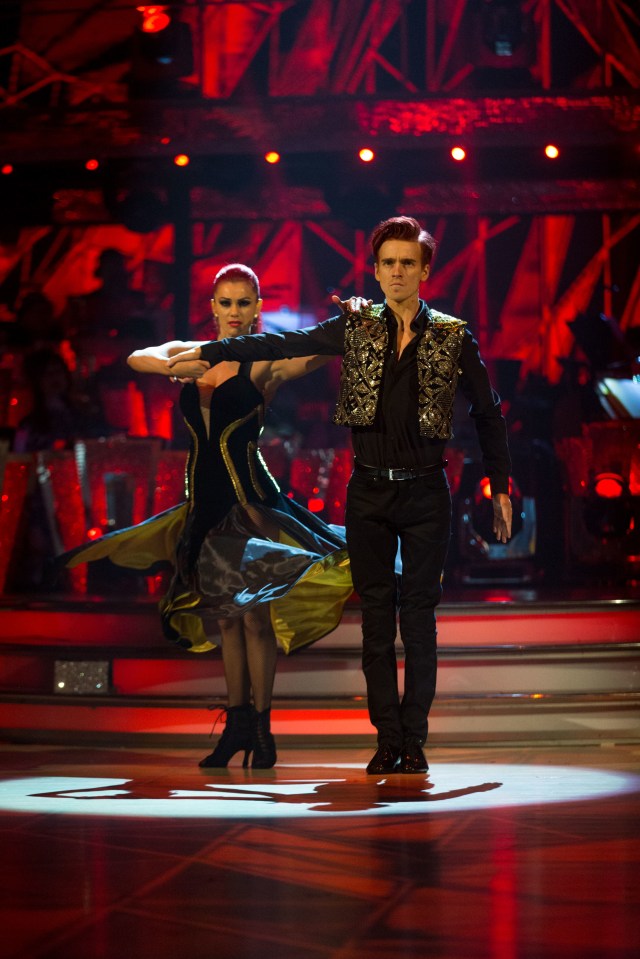 a man and a woman are dancing on a stage