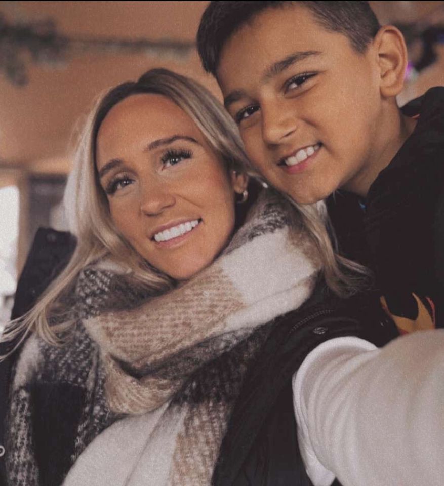 a woman and a boy are posing for a picture