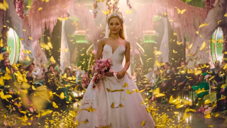a woman in a wedding dress is surrounded by butterflies