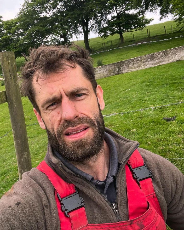 a man with a beard is wearing red overalls