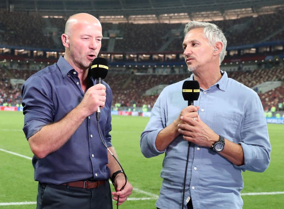 Alan Shearer and Gary Lineker at a soccer stadium, speaking into microphones.