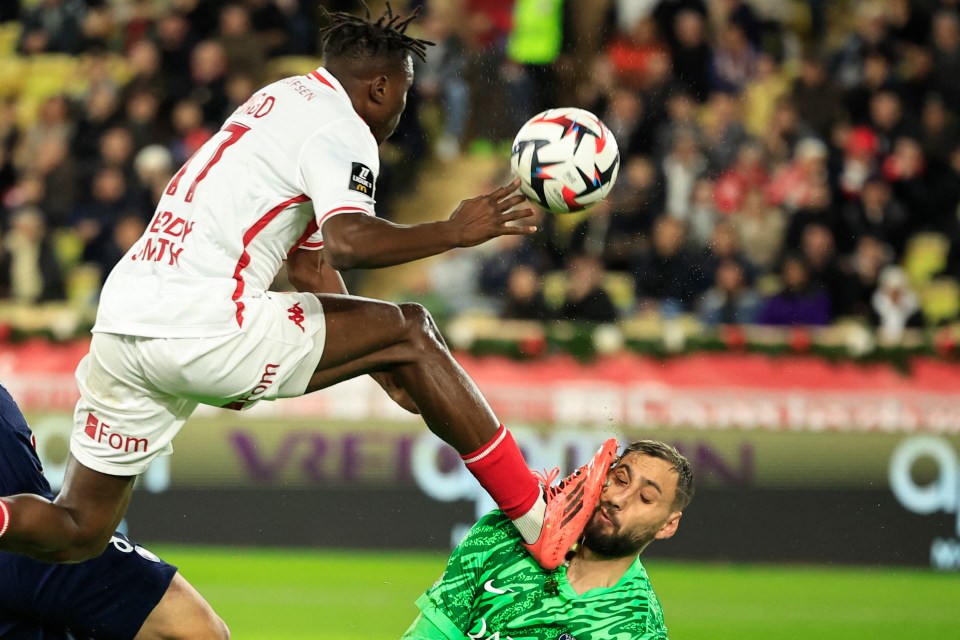 Soccer player #17 accidentally kicks the goalkeeper in the face.