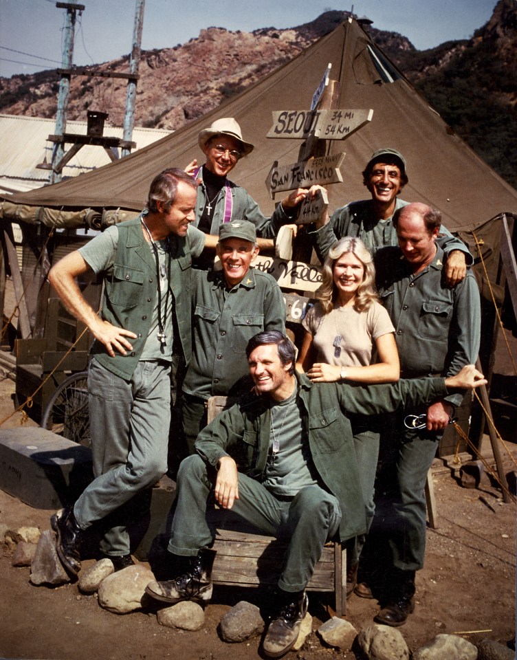 Cast of the 1970s TV series *M*A*S*H*, including Alan Alda and Loretta Swit.
