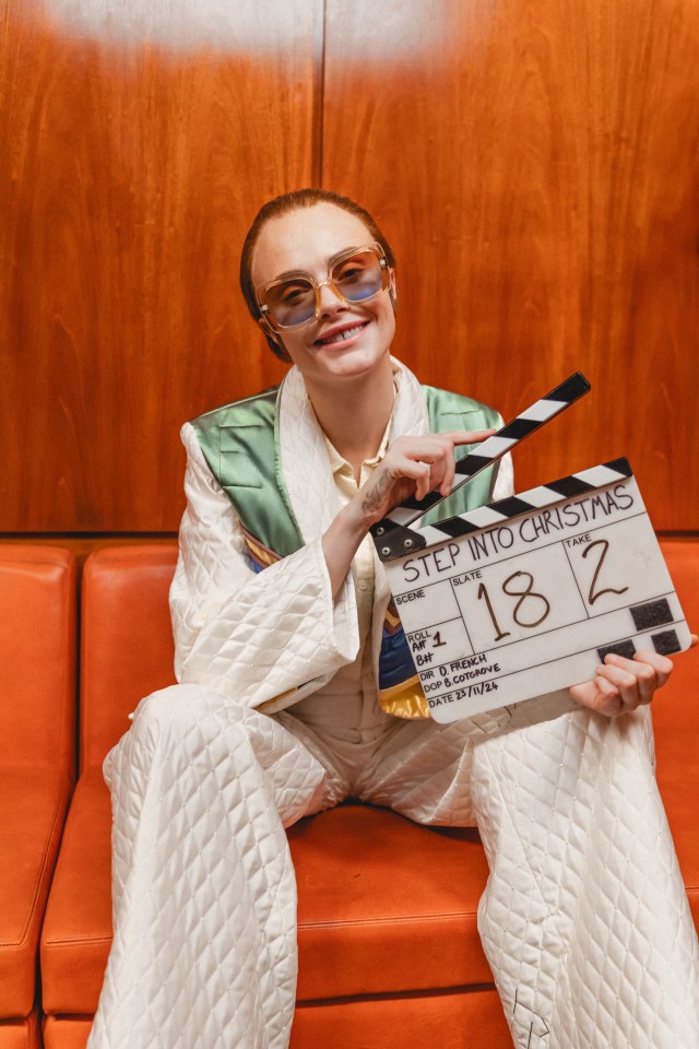 Cara Delevingne on the set of Elton John's "Step Into Christmas" music video remake.