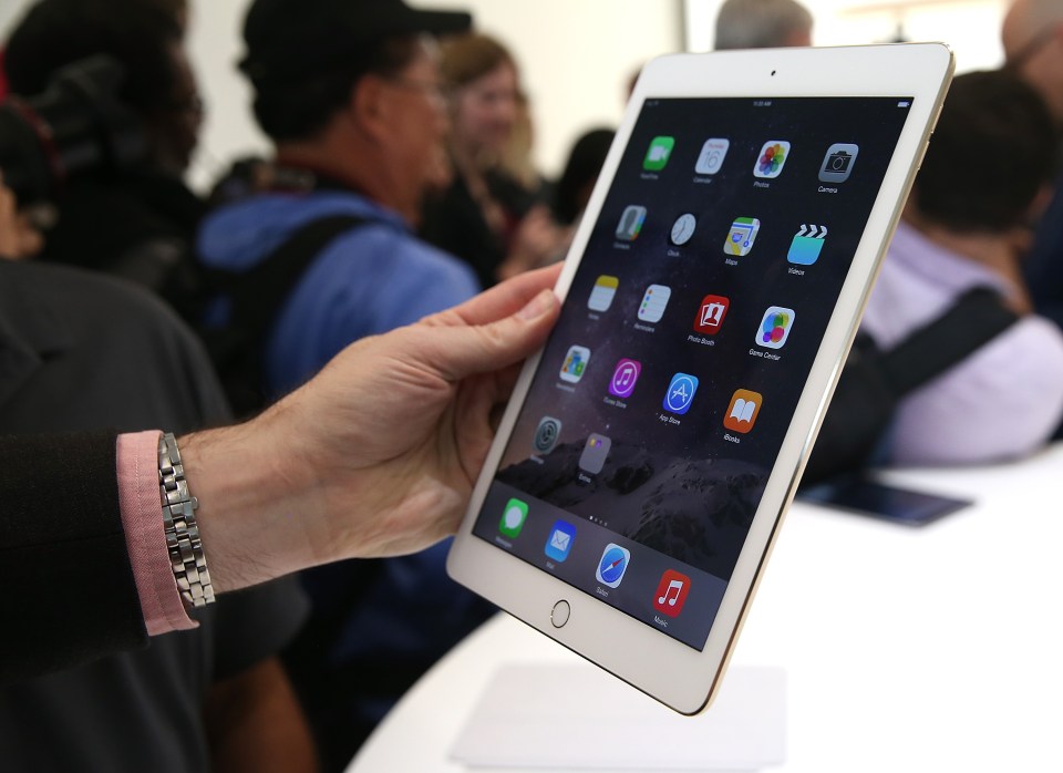 Person holding new iPad Air 2 at Apple event.