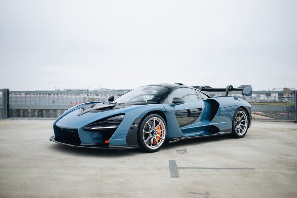 A blue McLaren Senna XP hypercar, one of ten prototypes, parked in a parking lot.
