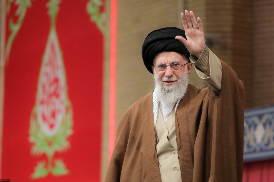 Ayatollah Ali Khamenei waving during a meeting with Iranian women.