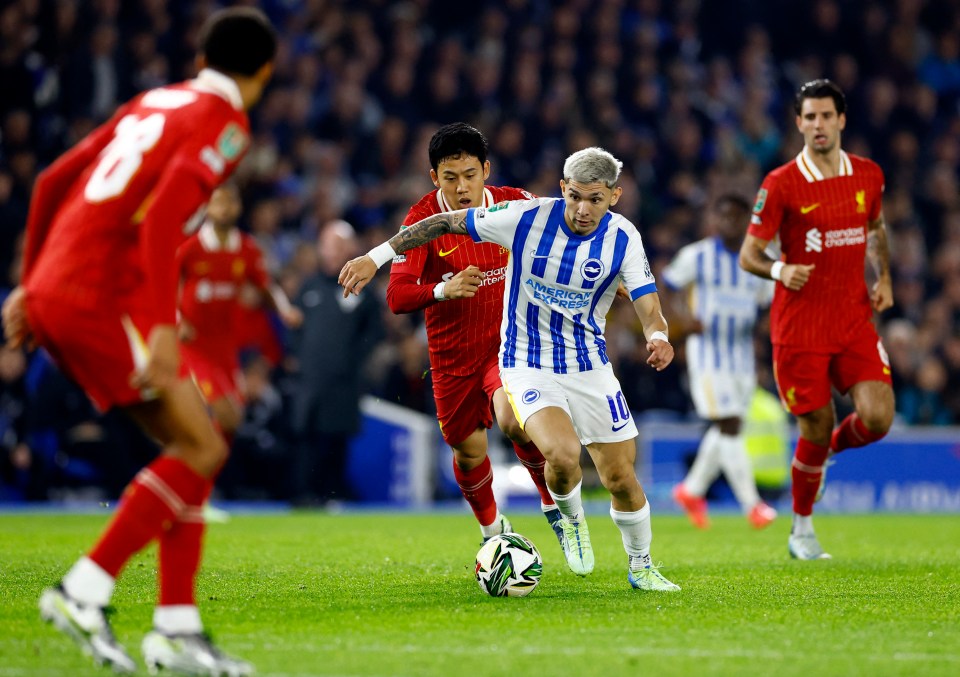 Brighton's Julio Enciso dribbling the ball past Liverpool's Wataru Endo.