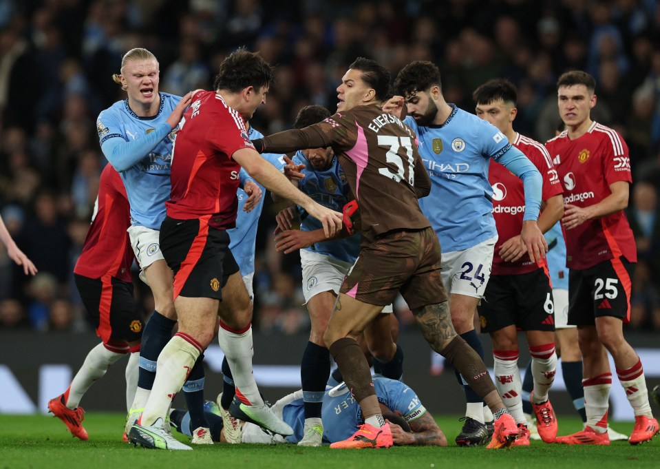 Manchester City's Kyle Walker on the ground during a clash with Manchester United players.
