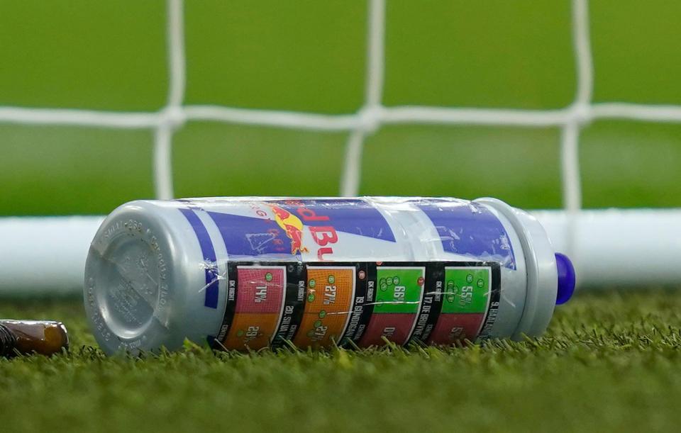 Drinks bottle with penalty taker instructions on the field.