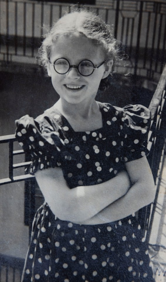 Black and white photo of Agnes Kaposi as a child, wearing a polka dot dress.