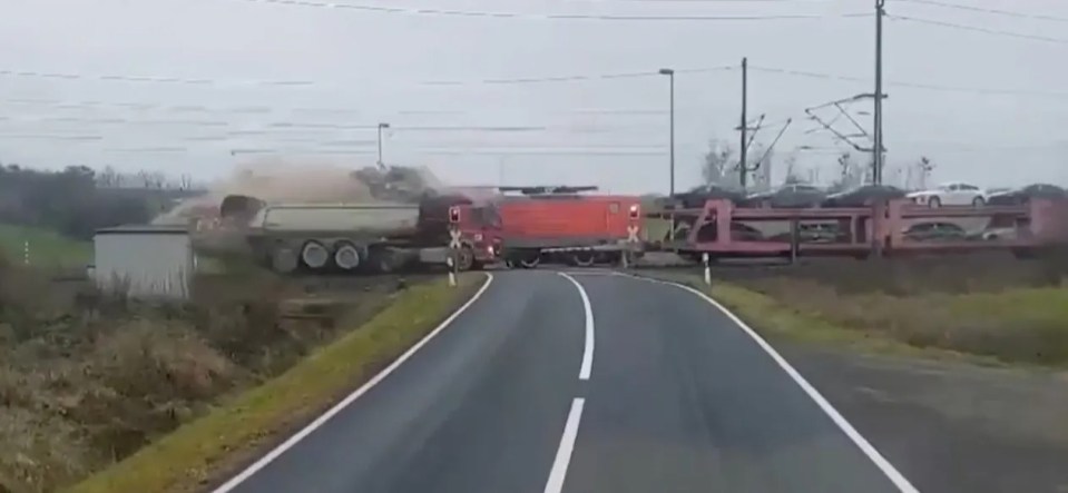 Freight train colliding with truck at a level crossing.