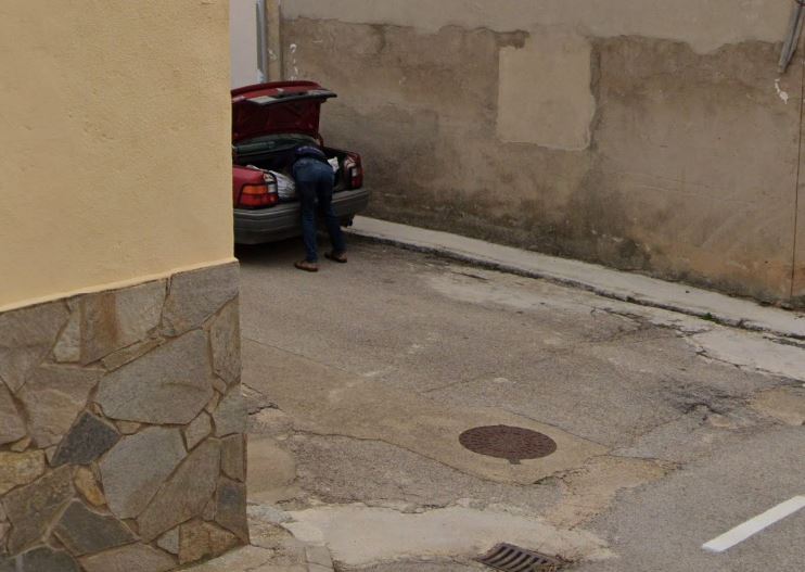 Person loading a car trunk.