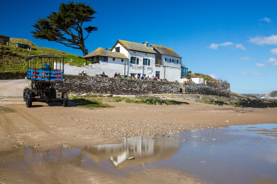 The Pilchard Inn on Burgh Island, with a tractor on the beach.
