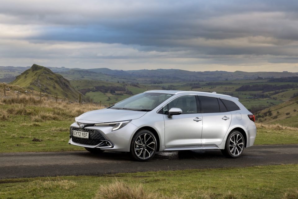 Silver Toyota Corolla Sports Touring estate on a road overlooking a valley.