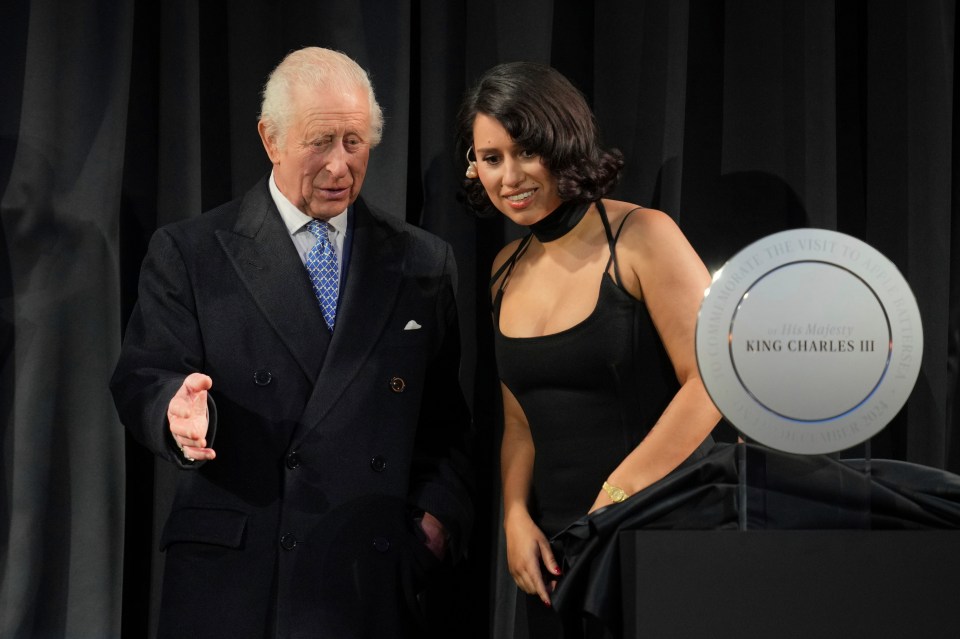 King Charles III and singer Raye unveil a plaque at Apple's UK headquarters.