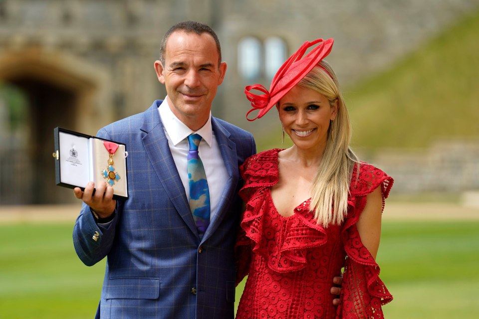 Martin Lewis and his wife Lara Lewington at an investiture ceremony; he is holding his CBE medal.